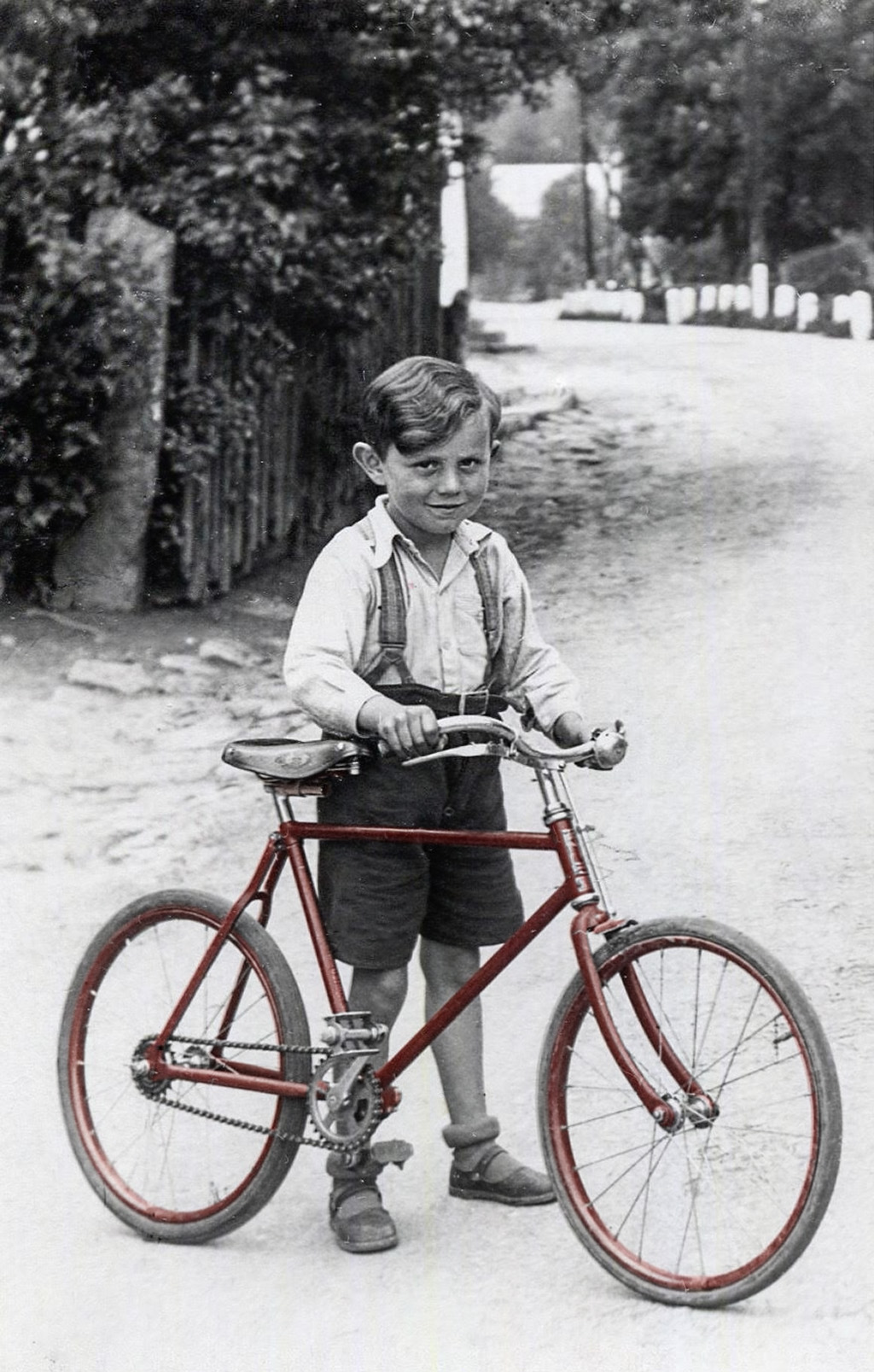 Josef Heinzel mit seinem Fahrrad in Pechgrün auf der Dorfstraße (mittleres Dorf), vor Haus 24.